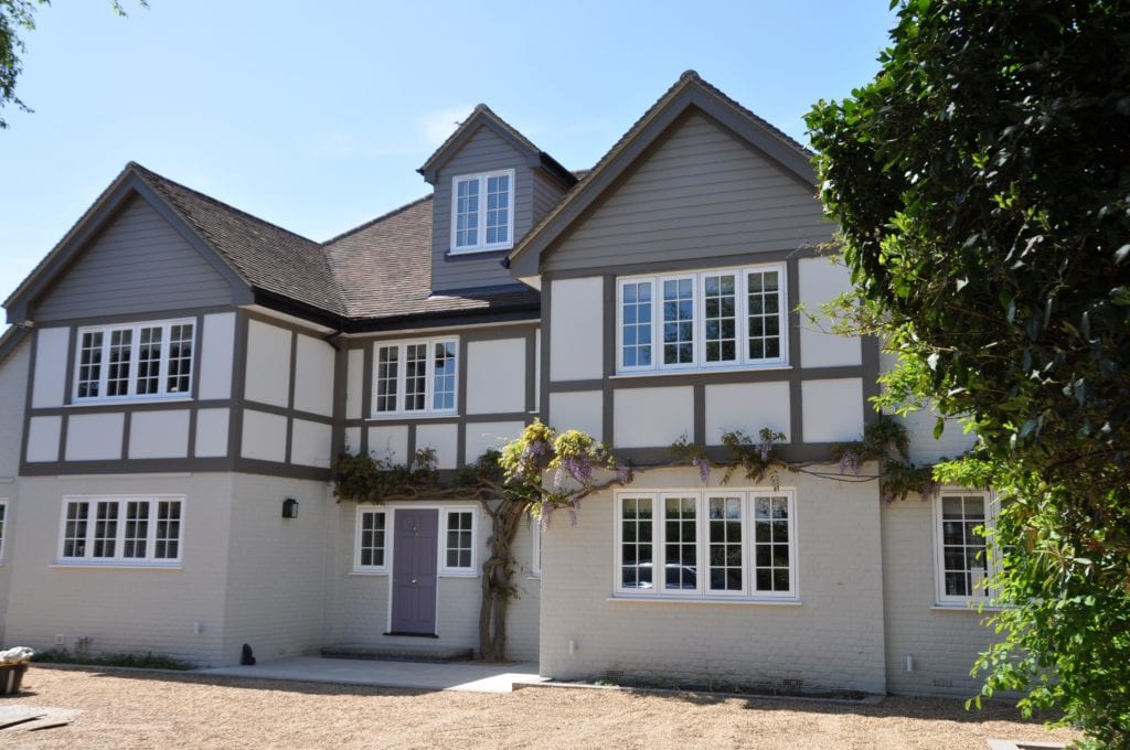 A renovated, double-gabled, 1930s, mock-Tudor property frontage.