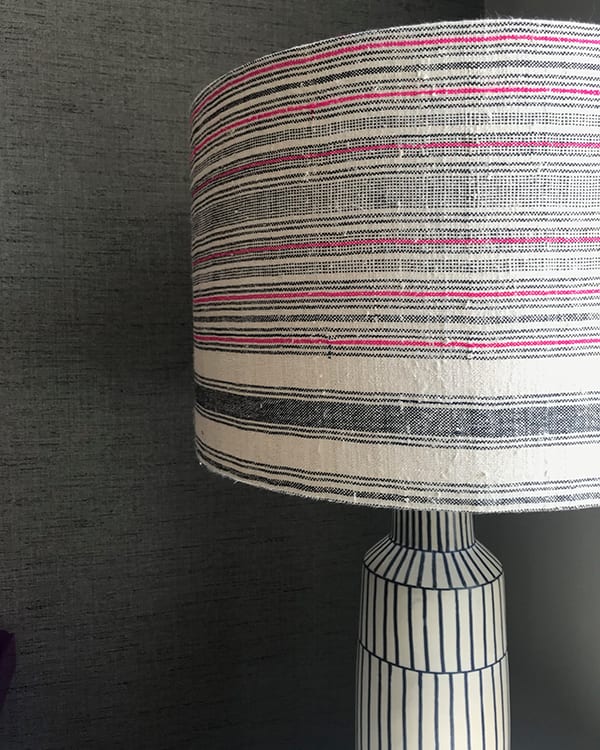 Black and white lampshade close up shot, with a pink stripe running through it in a slubby, vintage, Thai, handwoven hemp fabric.