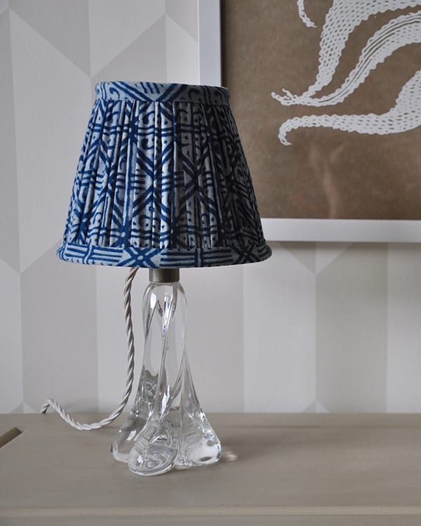 Close-up shot of a petite indigo block-print lampshade with a geometric grid design.