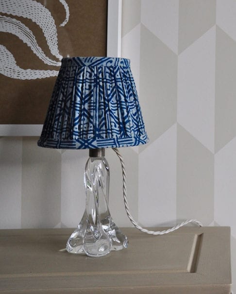 A petite, block-print indigo lampshade with a geometric grid design.