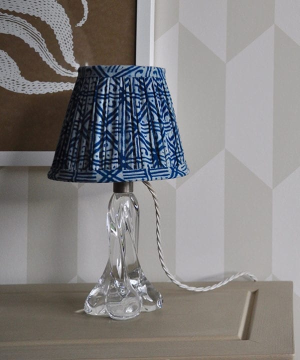 A petite, block-print indigo lampshade with a geometric grid design.