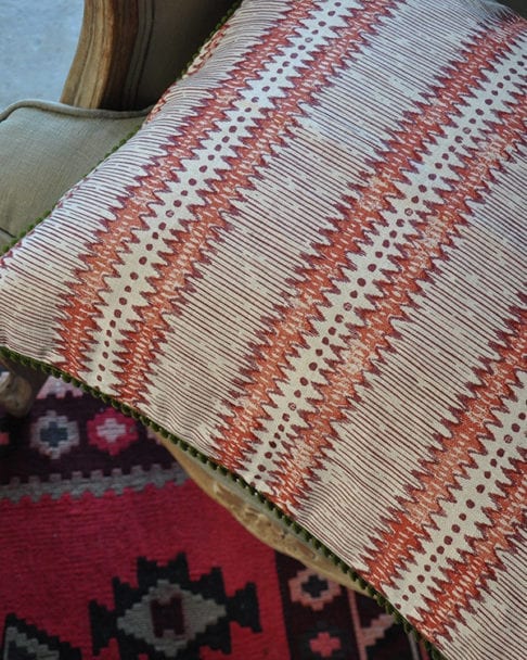 Red and white stripe cushion with handprinted zigzag design on linen.