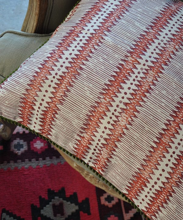 Red and white stripe cushion with handprinted zigzag design on linen.