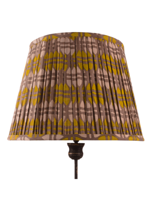 A large, mustard and putty, block-print gathered lampshade.