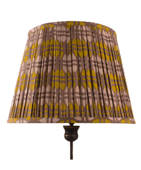 A large, mustard and putty, block-print gathered lampshade.