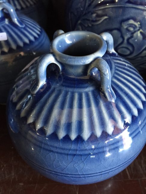 Small blue ceramic pot from Thailand showing the decorative detail and miniature urn handles.