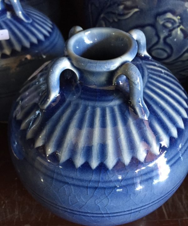 Small blue ceramic pot from Thailand showing the decorative detail and miniature urn handles.