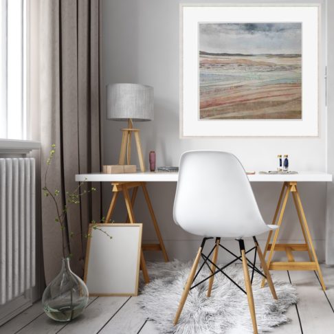 Irish coastal wall art print Dunes At Murlough Bay framed and styled in a home office setting with a modern white desk with wooden trestles, white chair and table lamp.