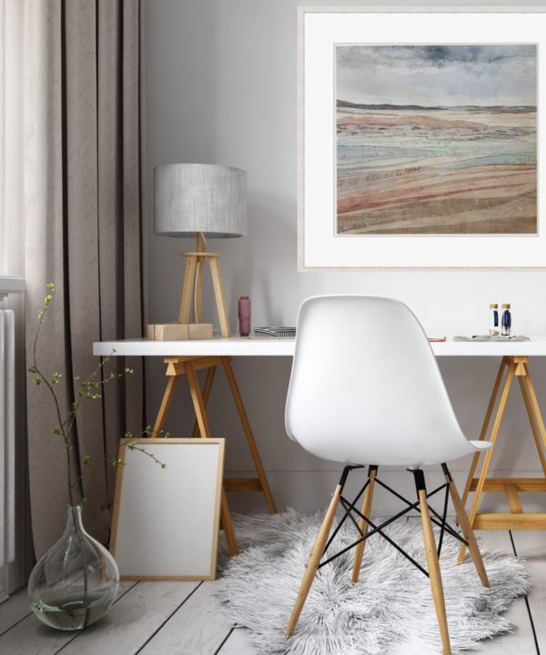 Irish coastal wall art print Dunes At Murlough Bay framed and styled in a home office setting with a modern white desk with wooden trestles, white chair and table lamp.