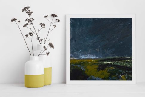 Framed Irish art print Dusk Is Here styled next to yellow pots filled with meadow flowers.