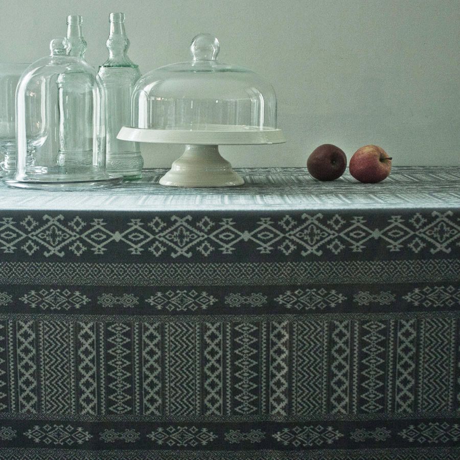 Charcoal grey tablecloth closeup depicting Arabian architectural motifs.