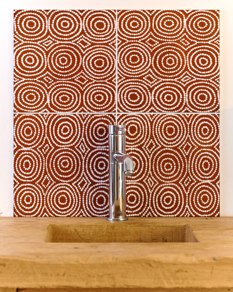 Indigenous, Aboriginal art wall tiles in a terracotta colourway.