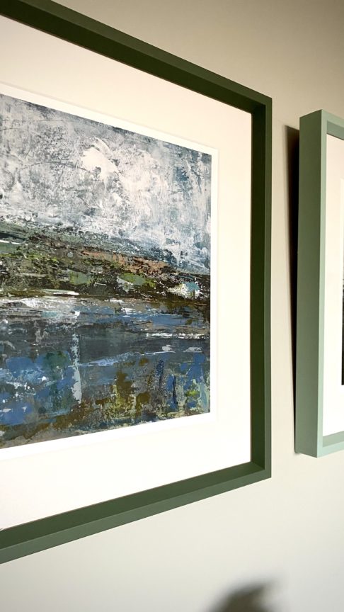 An Irish landscape print with a smart, sage green frame.