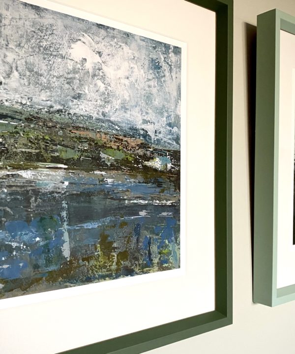 An Irish landscape print with a smart, sage green frame.