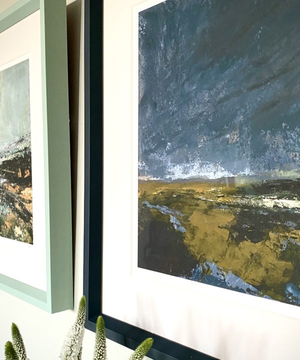 Close-up shot of a stormy Irish landscape scene print with an inky blue frame.