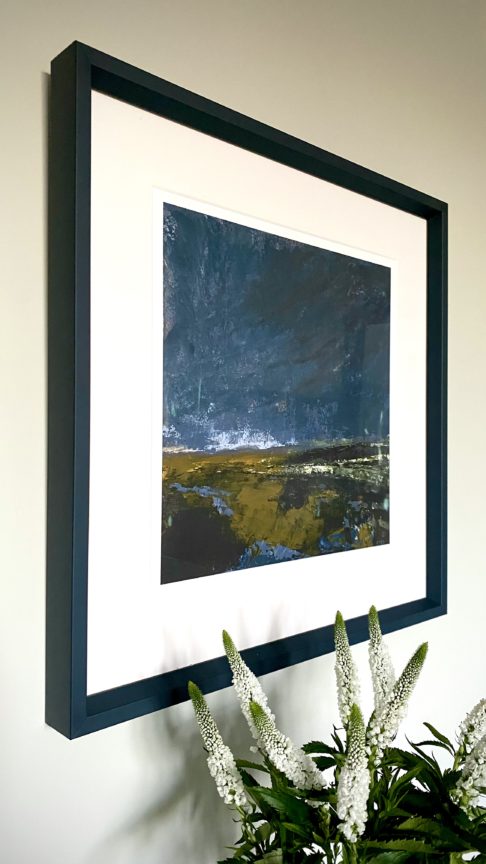 A stormy Irish landscape scene print with an inky blue frame.