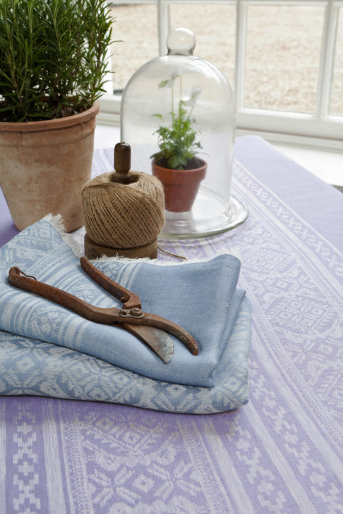 Hungarian-folk-inspired table linen in soft lilac and baby blues.