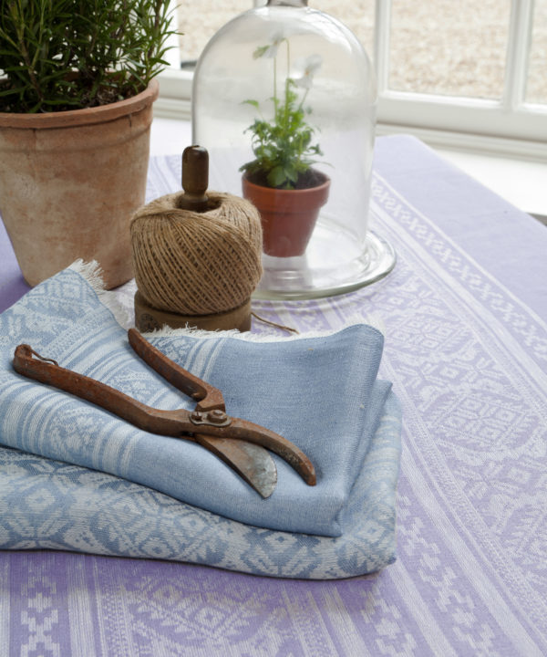 Hungarian-folk-inspired table linen in soft lilac and baby blues.