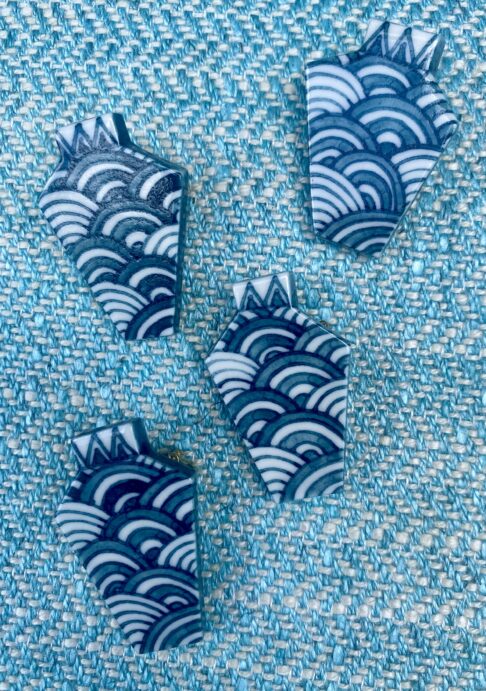 Hand-painted ceramic brooches with the Japanese wave detail.