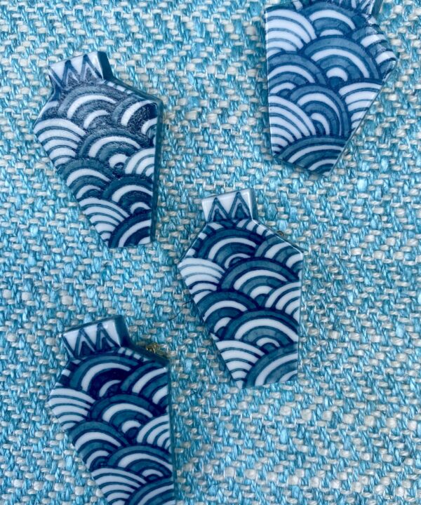 Hand-painted ceramic brooches with the Japanese wave detail.
