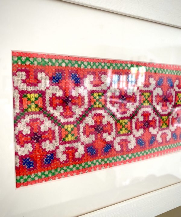 Framed fabric wall art showcasing a panel of hand-embroidered Thai textile, sourced in north of the country.