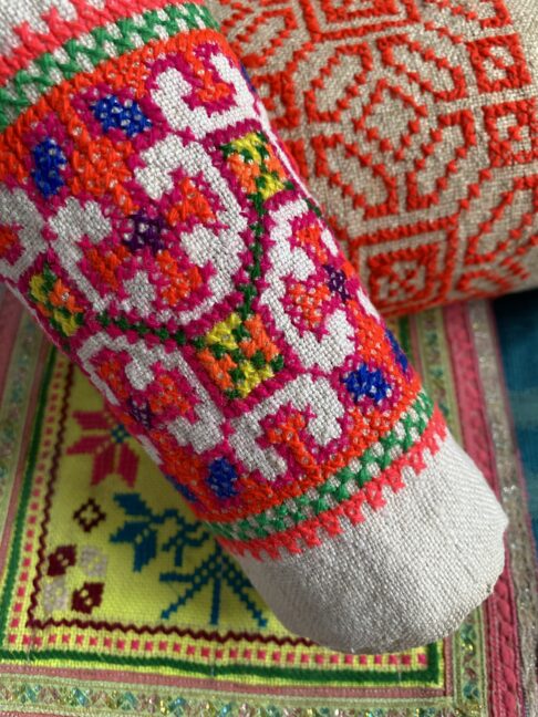 Close up shot of colourful, vintage Thai embroidered trims used for framed wall art.