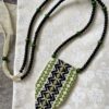 A statement green necklace handmade using vintage embroidered textiles from Slovenia.