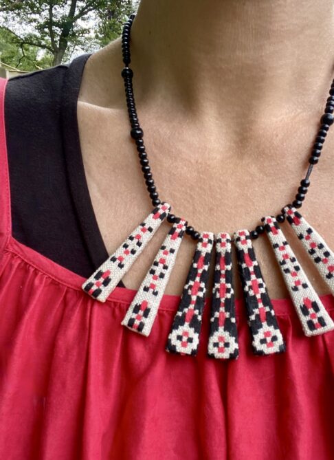 A pretty, red and black summer necklace handmade from vintage embroidered textiles.
