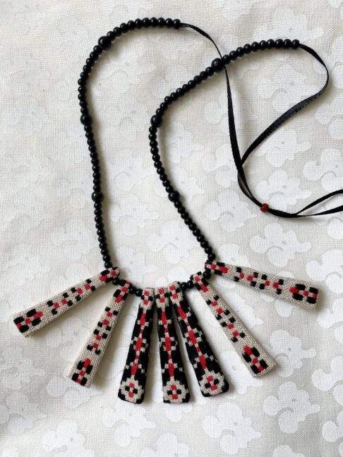 A pretty, Boho-style necklace with beaded ribbon and vintage embroidered textile.