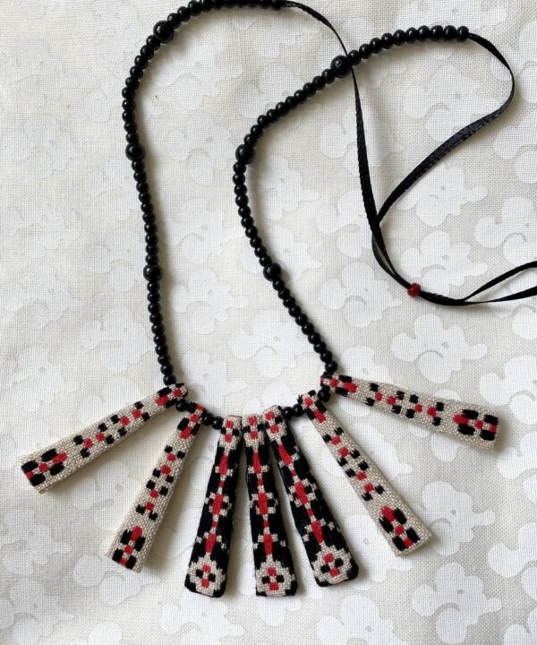 A pretty, Boho-style necklace with beaded ribbon and vintage embroidered textile.