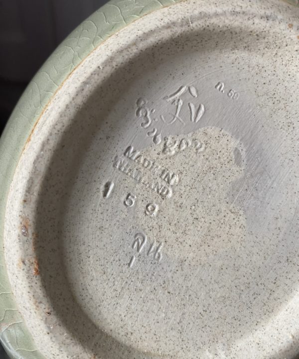 Detail of the backstamp on a handmade celadon pot from Thailand.