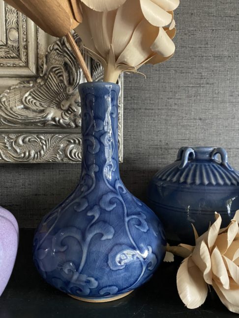 Blue ceramic pot handmade in northern Thailand displayed against a grey backdrop.