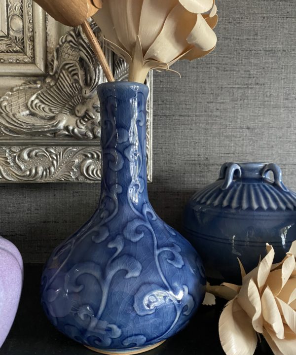 Blue ceramic pot handmade in northern Thailand displayed against a grey backdrop.