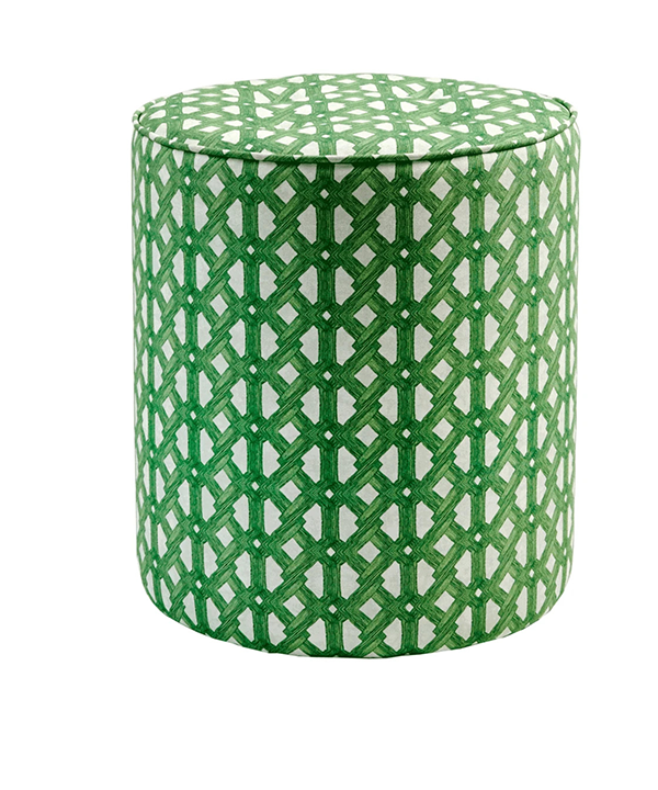 A small, patterned green pouffe with African geometric fabric upholstery.