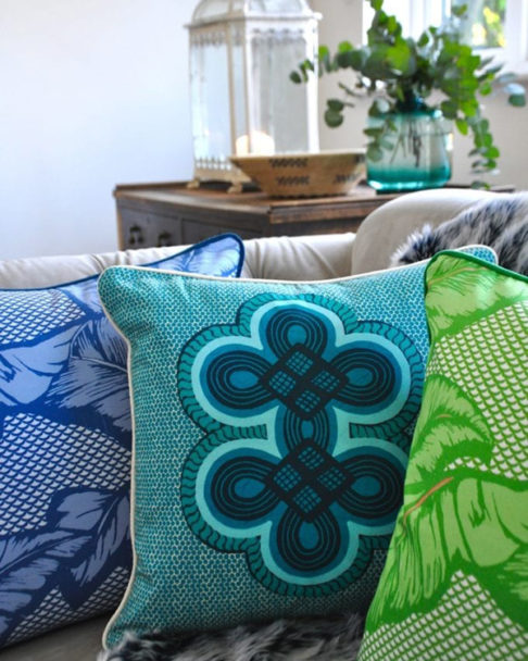 Brightly coloured African style cushions on a sofa.