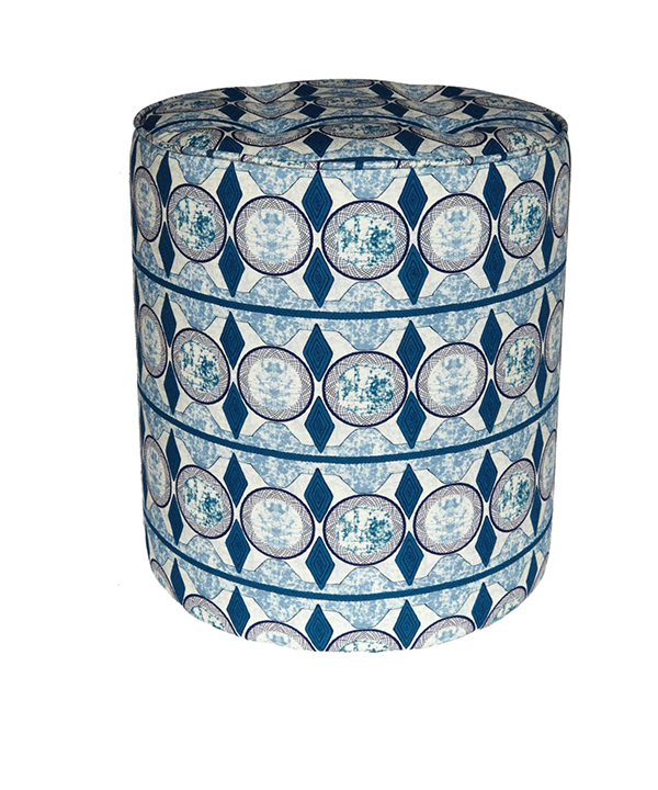 A chic, blue pouffe or small footstool in a modern African fabric.