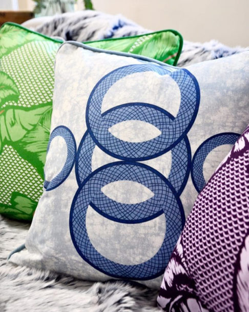 Boldly patterned African style cushions on a sofa.