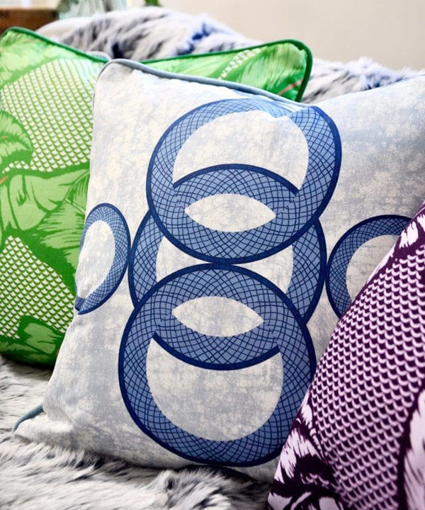 Boldly patterned African style cushions on a sofa.