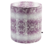 A purple pouffe with an African-inspired design with faded horizontal stripes.