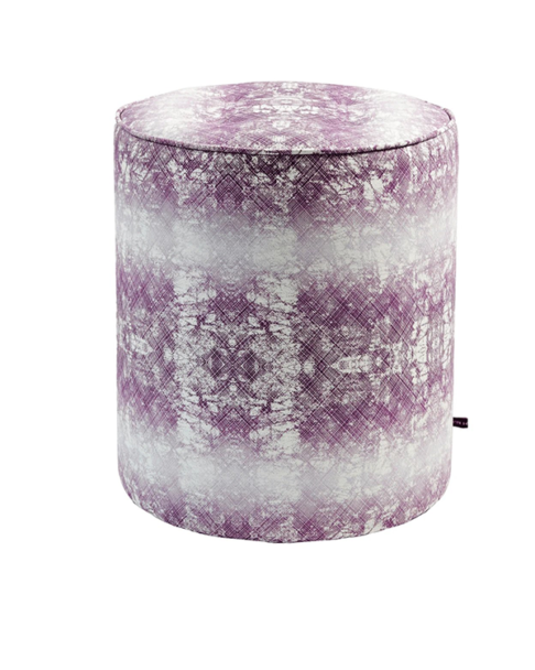 A purple pouffe with an African-inspired design with faded horizontal stripes.