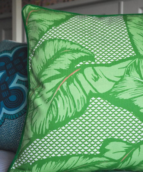 A palm print cushion in a vibrant green hue.