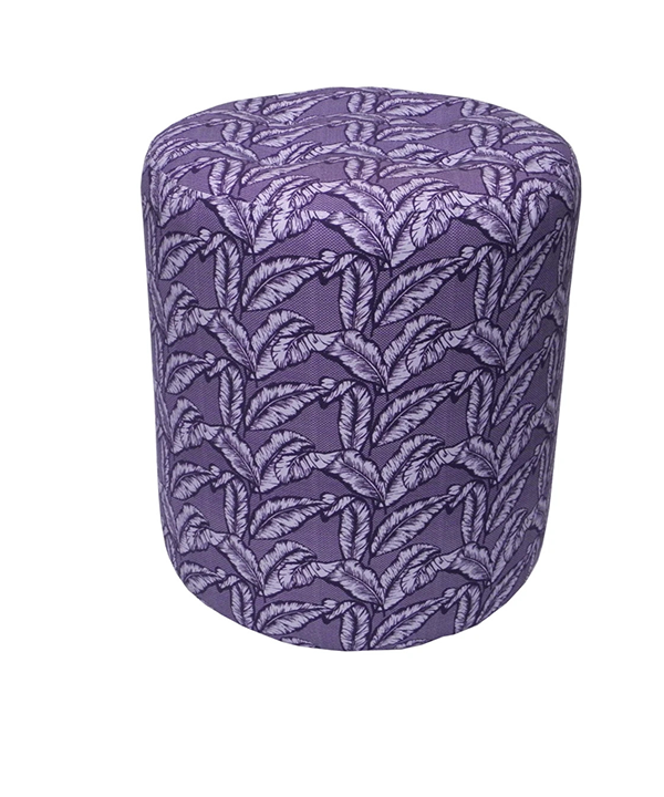 A purple upholstered dressing table stool with a tropical palm print.