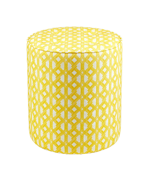 A yellow patterned footstool with stylish, modern African geometric print upholstery.