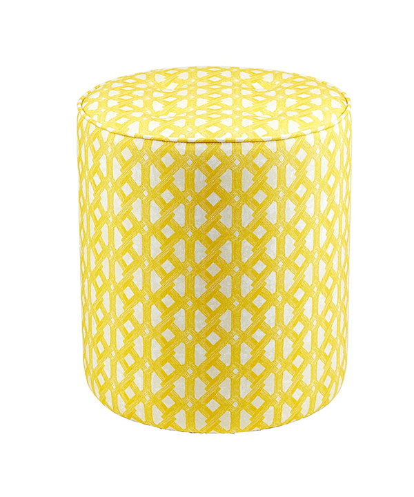 A yellow patterned footstool with stylish, modern African geometric print upholstery.