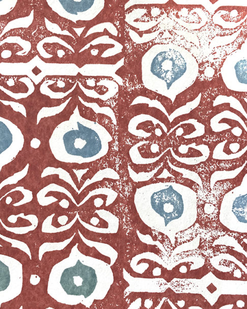 Detail of a bold, red wallpaper for walls with soft blue accents.