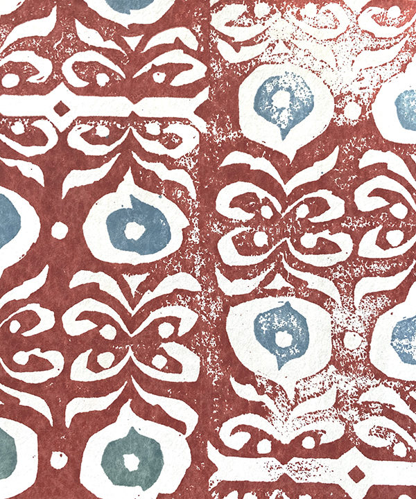 Detail of a bold, red wallpaper for walls with soft blue accents.