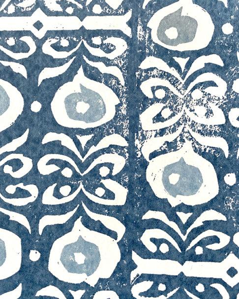 Detail of an indigo-hued, dark blue wallpaper with a Middle Eastern-inspired pattern.