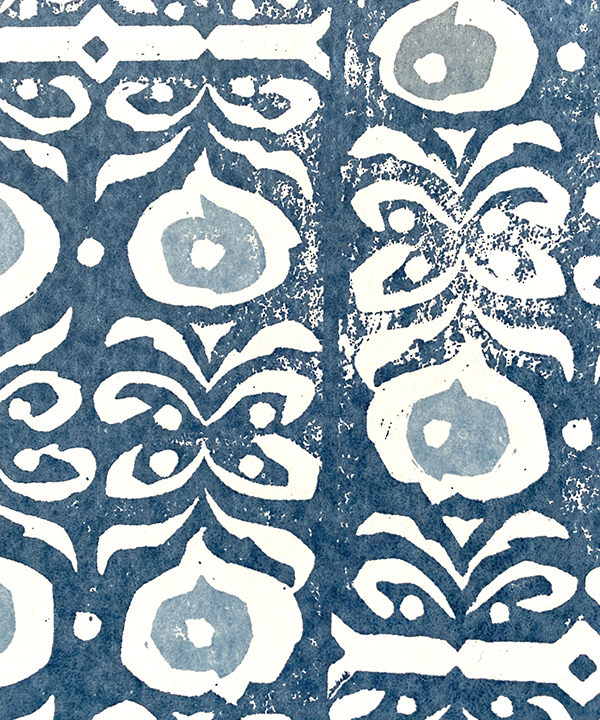 Detail of an indigo-hued, dark blue wallpaper with a Middle Eastern-inspired pattern.