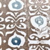 Detail shot of a brown and blue wallpaper with a Middle-Eastern inspired design.