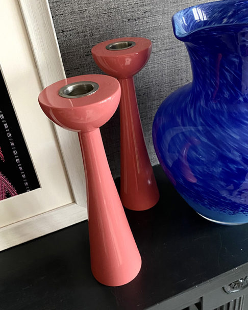 Pink candlesticks in gloss Coral with a retro, Scandinavian-style silhouette.